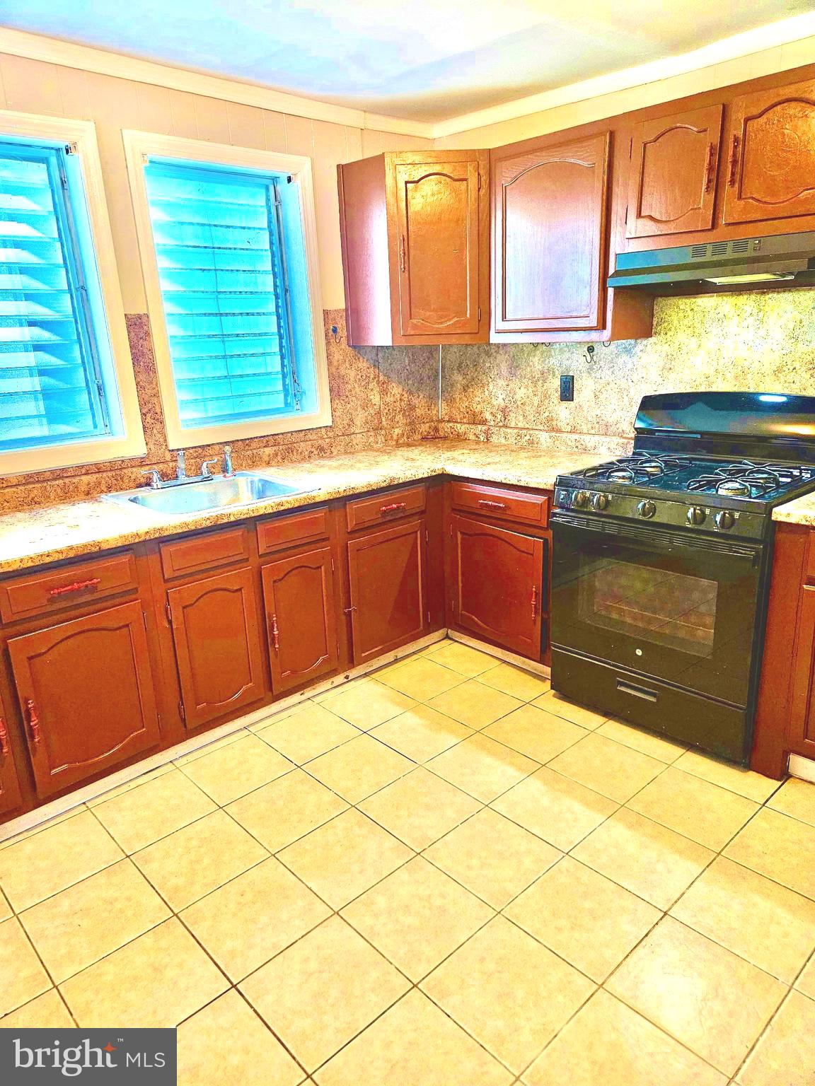 20 Park Lane Hamilton, NJ 08609 - Photo 4 of 12 a kitchen with stainless steel appliances granite countertop a stove a sink and a microwave