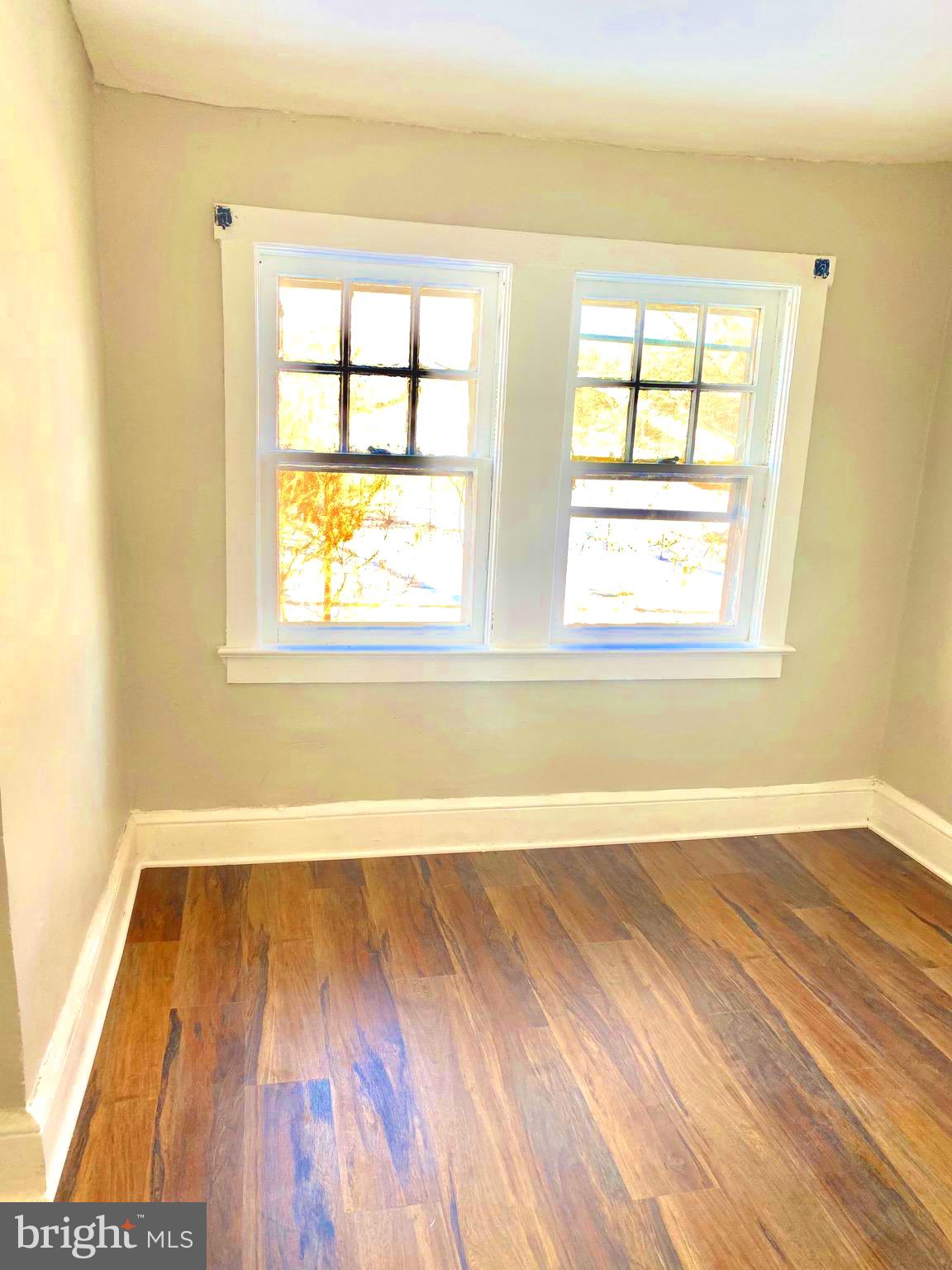 20 Park Lane Hamilton, NJ 08609 - Photo 7 of 12 an empty room with wooden floor and windows