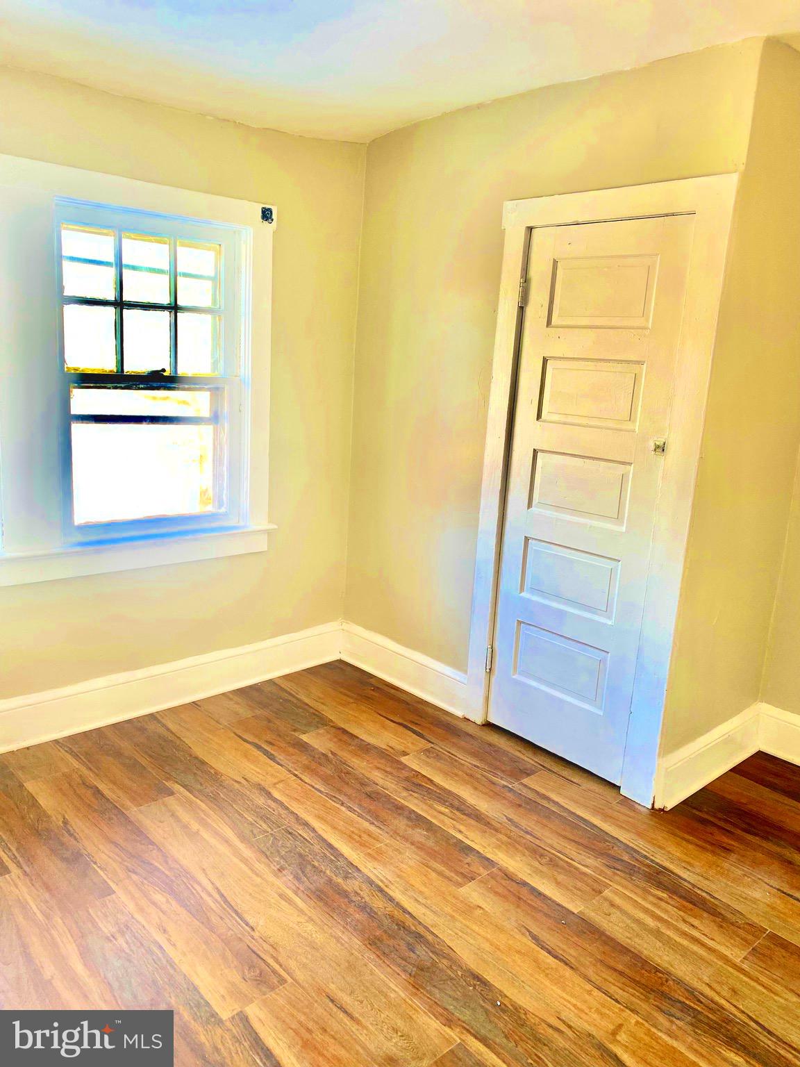 20 Park Lane Hamilton, NJ 08609 - Photo 8 of 12 an empty room with wooden floor and sliding door