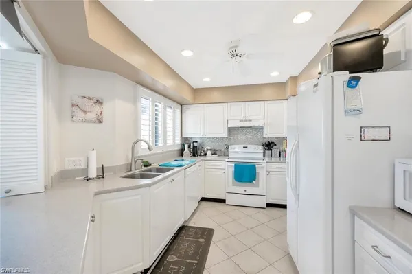 a kitchen with a sink cabinets and window
