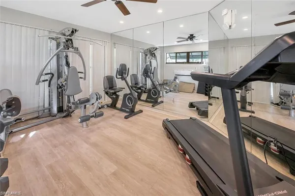 a room with gym equipment and a chandelier
