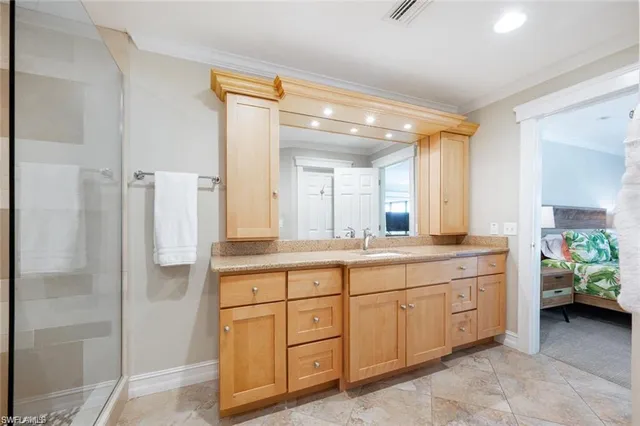 a spacious bathroom with a double vanity sink and a mirror