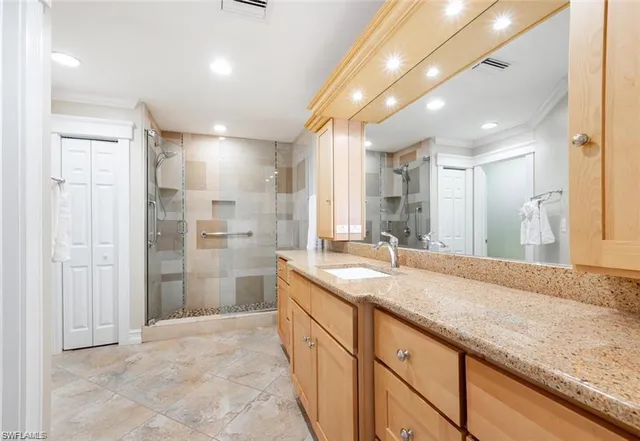 a bathroom with a granite countertop sink mirror and shower