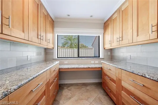 a kitchen with granite countertop a sink and a window