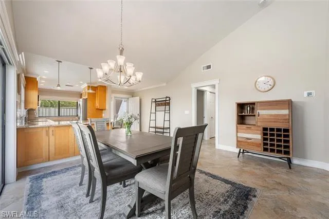 a view of a dining room with furniture and chandelier