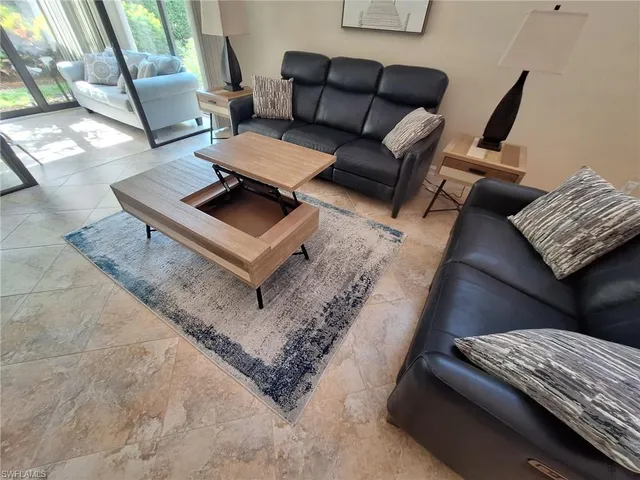 a living room with furniture and a rug