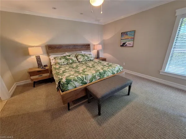 a bedroom with a bed chair and window