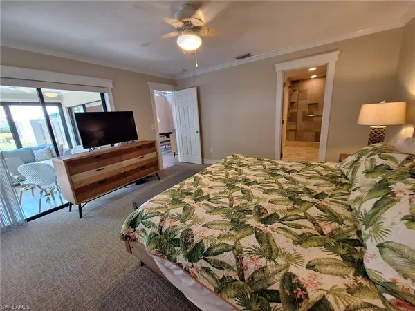 a bedroom with a bed and flat screen tv
