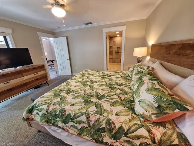 a bedroom with a bed and a television