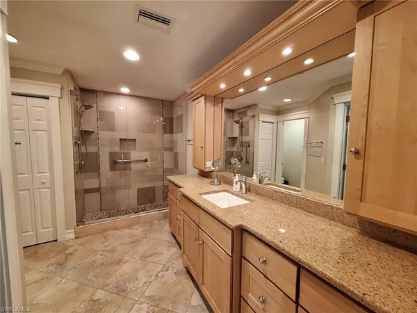 a bathroom with a sink and a large mirror
