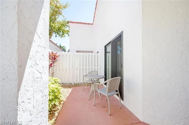 a view of a hallway with chairs and a potted plant