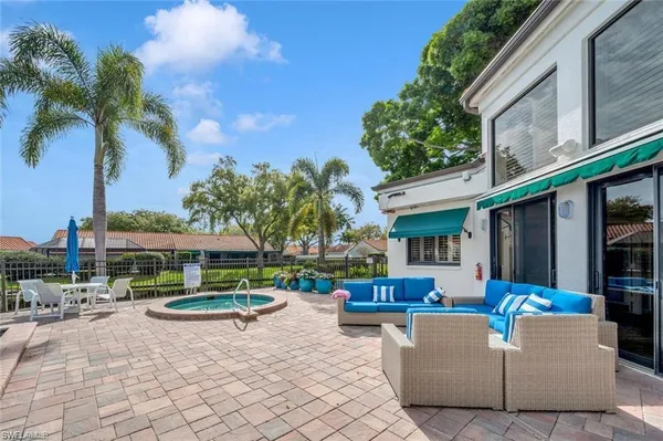a view of a patio with couches and a fire pit