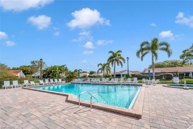 a view of a swimming pool and trees in a patio
