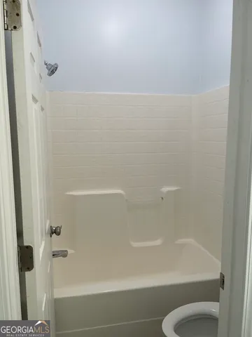 a bathroom with a shower and a toilet