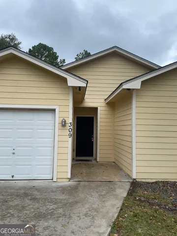 a front view of a house with garage