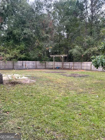 a view of a swimming pool with an outdoor seating and a forest
