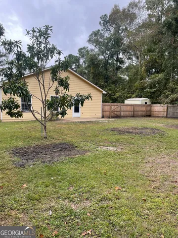 a view of a backyard with large trees