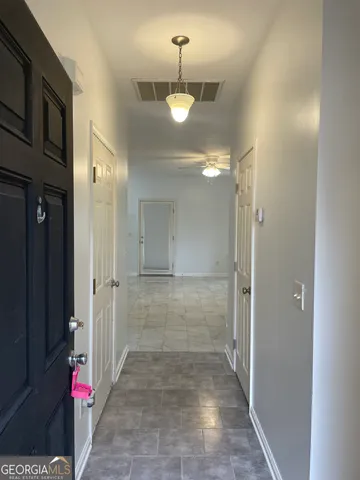 a view of a hallway with a chandelier