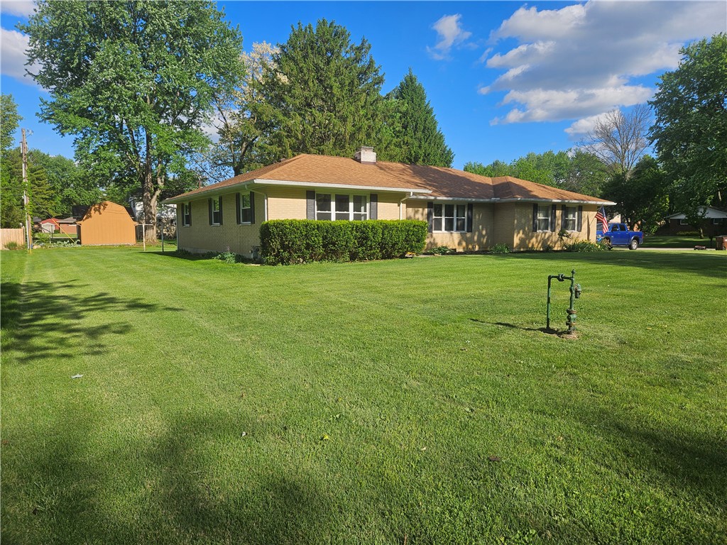 3998 Willowcrest Road Beavercreek, OH 45430 - Photo 3 of 41 This ranch-style home features a classic brick exterior and an expansive green lawn.