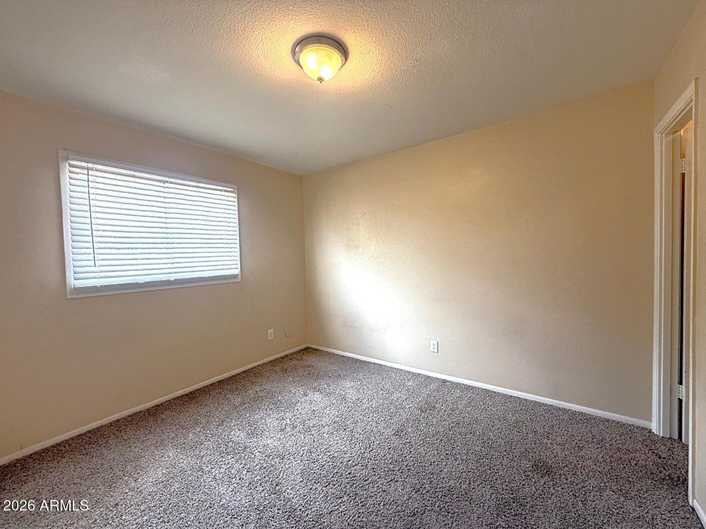 4625 South Rita Lane Tempe, AZ 85282 - Photo 8 of 16 an empty room with a empty space and a window