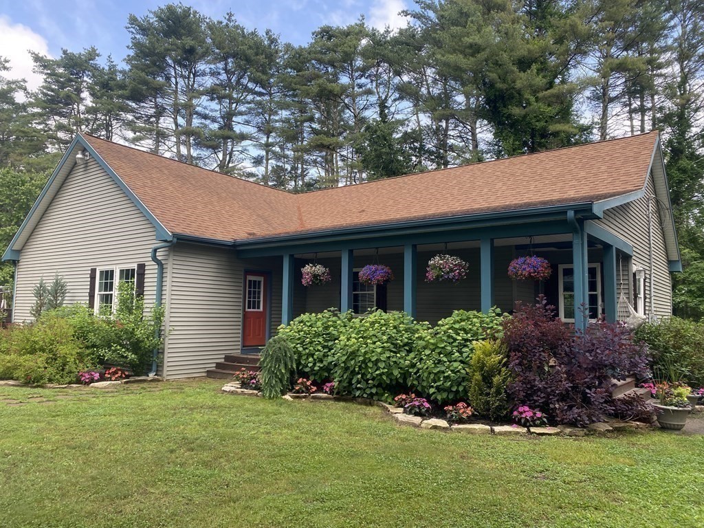 121 River Road Ware, MA 01082 - Photo 1 of 39 a front view of a house with a yard and garage