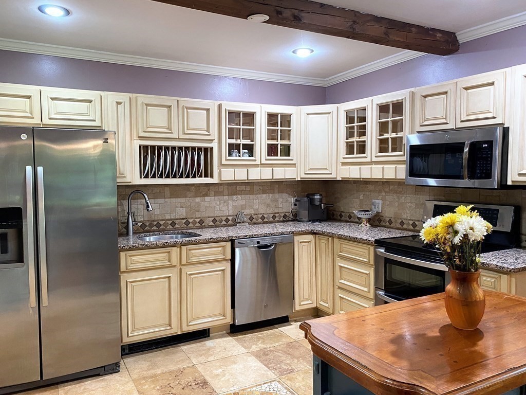 121 River Road Ware, MA 01082 - Photo 16 of 39 a kitchen with stainless steel appliances granite countertop a stove refrigerator sink and microwave