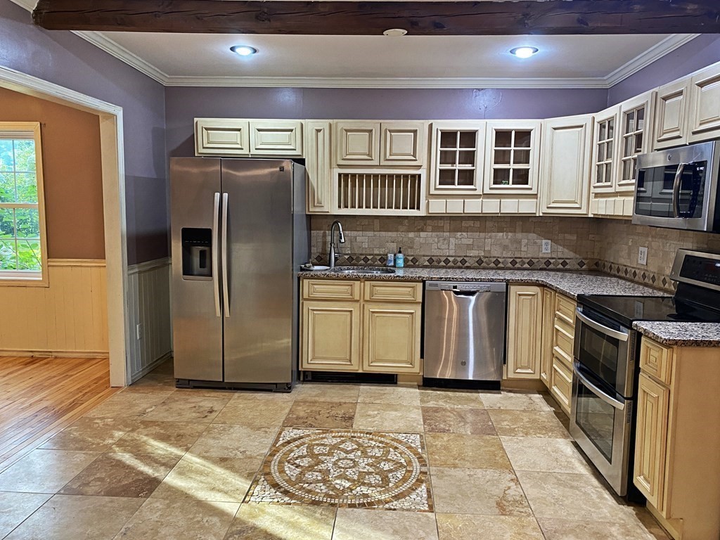 121 River Road Ware, MA 01082 - Photo 17 of 39 a kitchen with stainless steel appliances granite countertop a stove a sink and a refrigerator