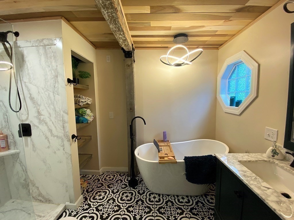 121 River Road Ware, MA 01082 - Photo 32 of 39 a bathroom with a granite countertop sink a mirror and shower
