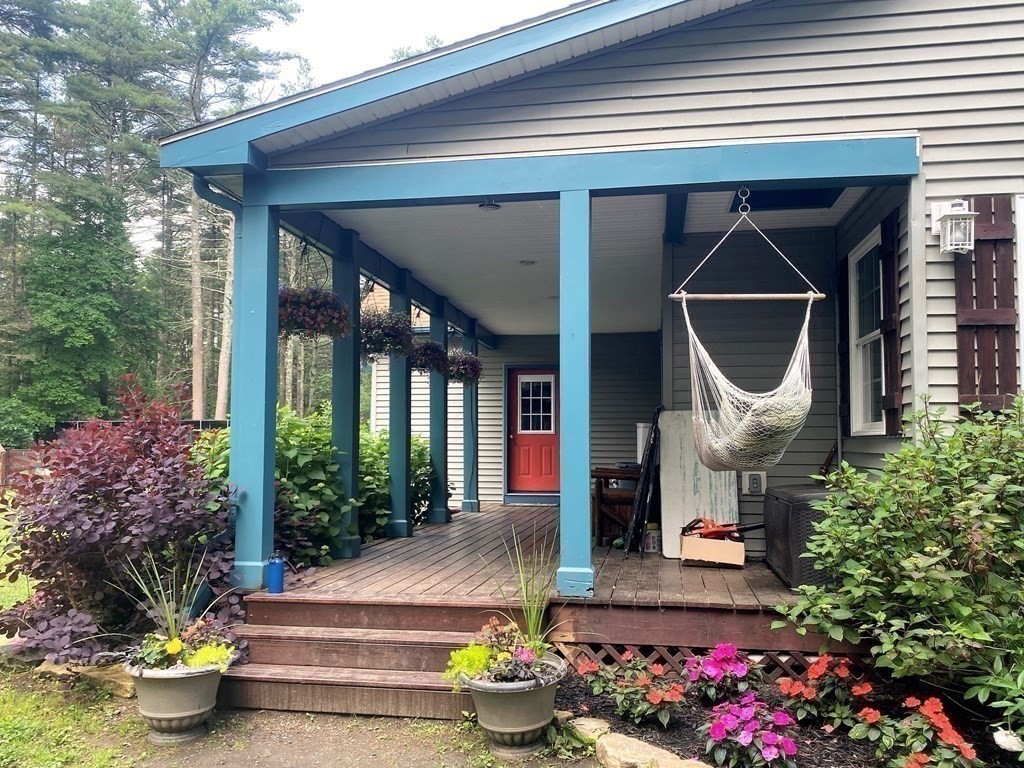 121 River Road Ware, MA 01082 - Photo 6 of 39 a front view of a house with outdoor seating and potted plants