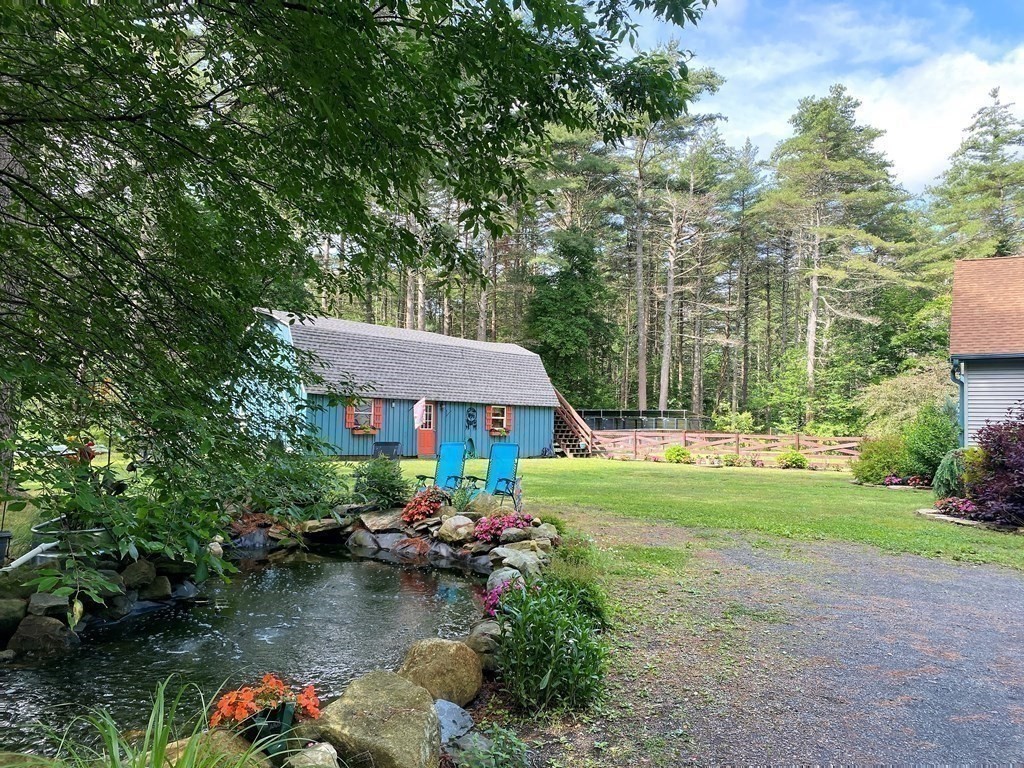 121 River Road Ware, MA 01082 - Photo 10 of 39 a view of a house with a yard and a garden