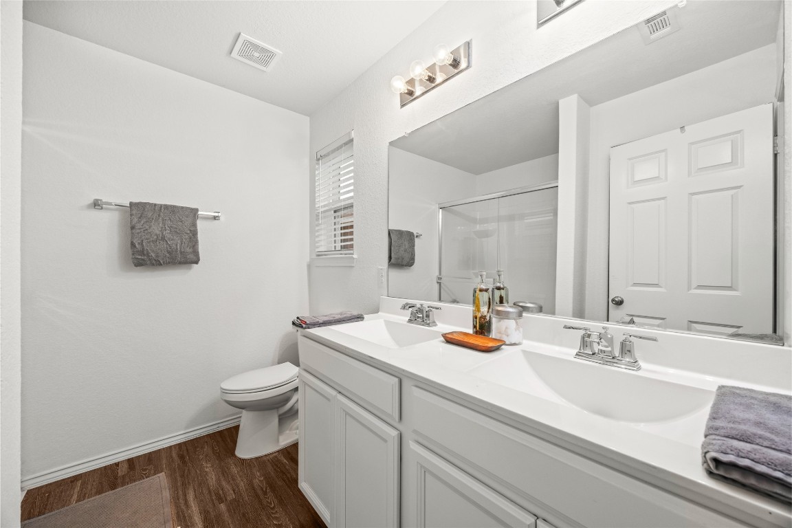 24026 Swather Way Hockley, TX 77447 - Photo 20 of 37 a bathroom with a toilet sink and mirror