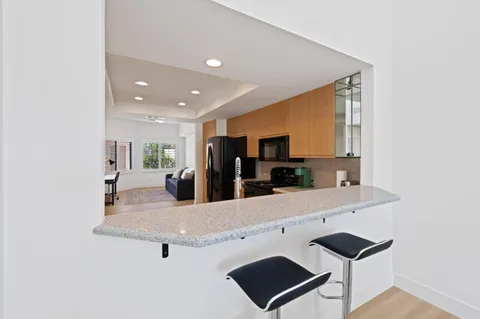 a kitchen with a refrigerator stove and sink