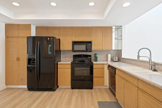 a kitchen with stainless steel appliances a refrigerator and a stove