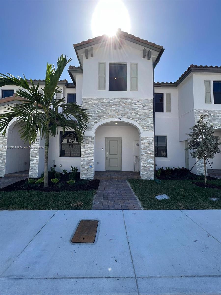 11774 Southwest 246th Street, Unit 11774 Homestead, FL 33032 - Photo 1 of 17 a front view of house with yard and green space
