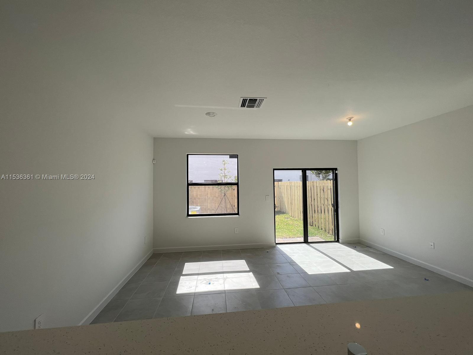 11774 Southwest 246th Street, Unit 11774 Homestead, FL 33032 - Photo 11 of 17 an empty room with windows