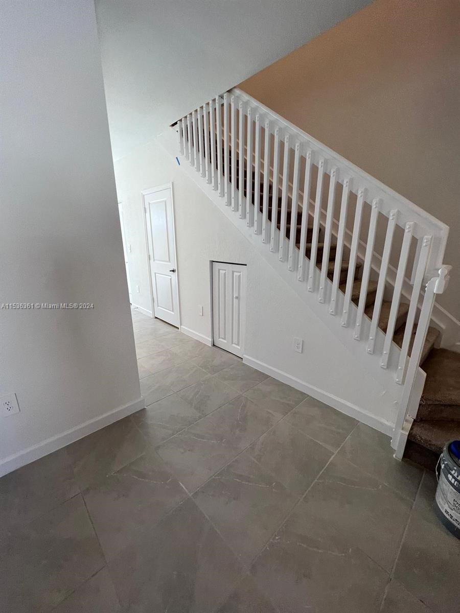 11774 Southwest 246th Street, Unit 11774 Homestead, FL 33032 - Photo 14 of 17 a view of a hallway with staircase