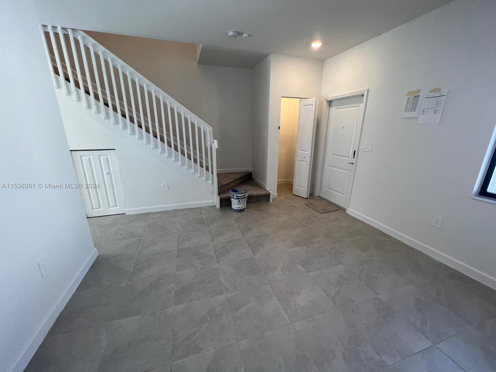 11774 Southwest 246th Street, Unit 11774 Homestead, FL 33032 - Photo 15 of 17 a view of an empty room with stairs