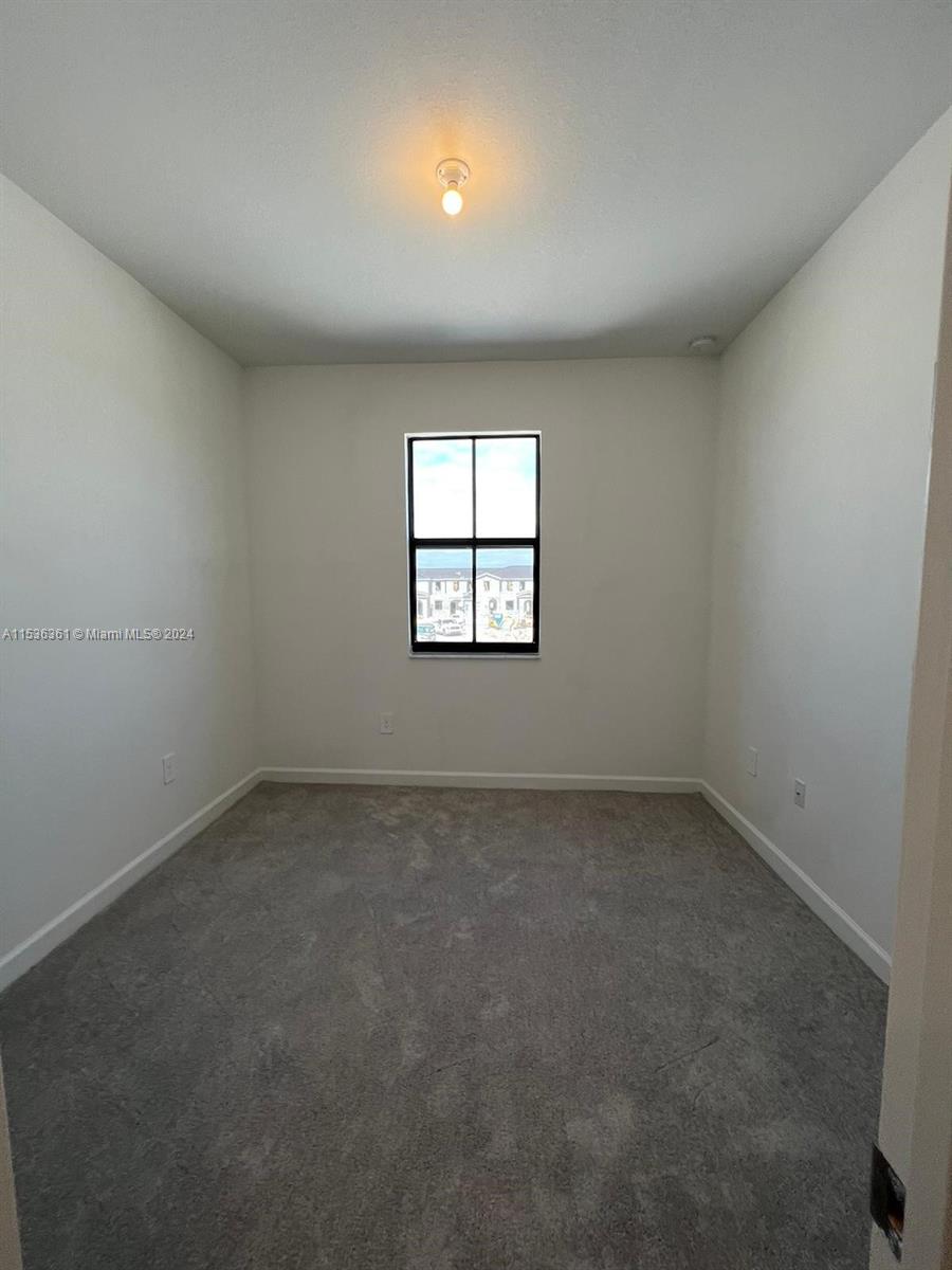 11774 Southwest 246th Street, Unit 11774 Homestead, FL 33032 - Photo 17 of 17 an empty room with a window