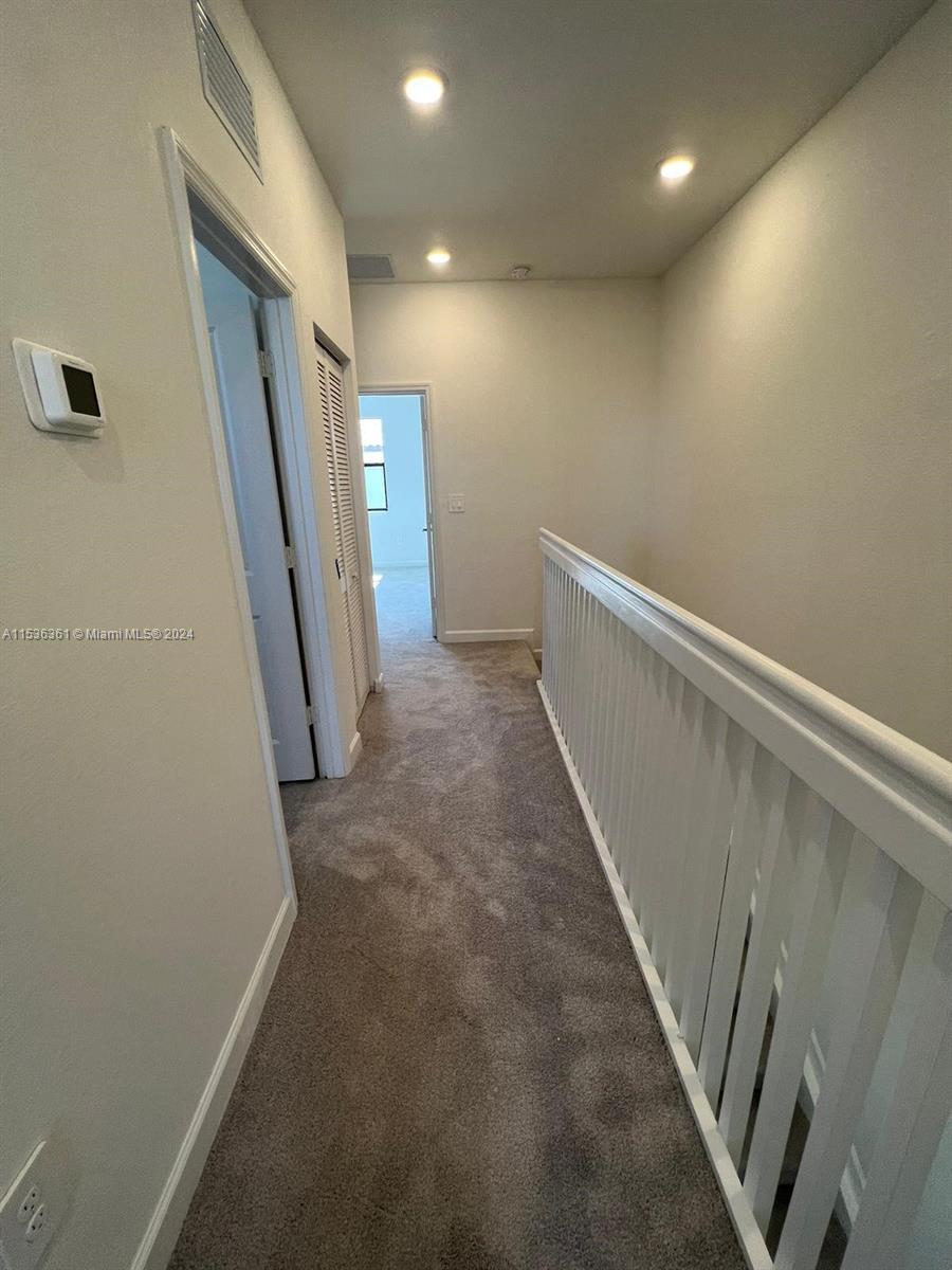 11774 Southwest 246th Street, Unit 11774 Homestead, FL 33032 - Photo 3 of 17 a view of hallway with stairs