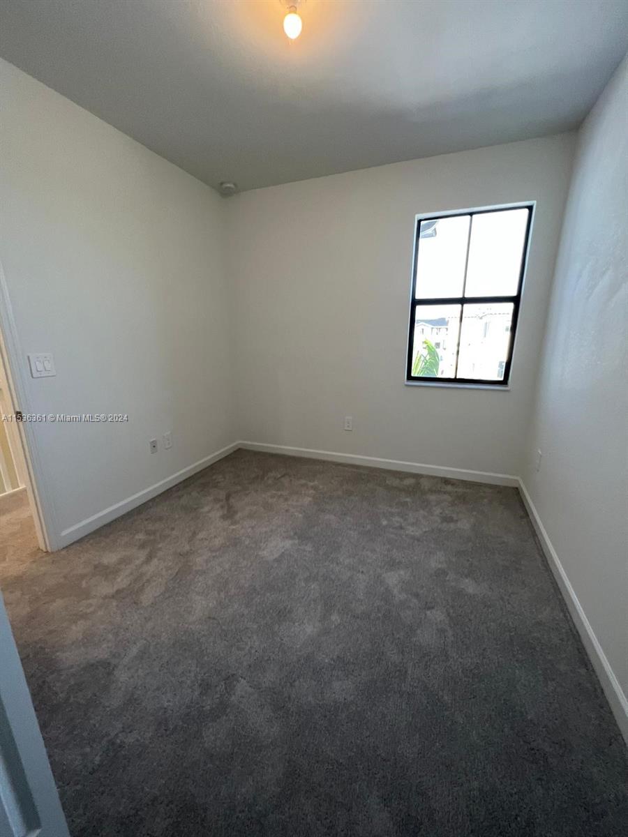 11774 Southwest 246th Street, Unit 11774 Homestead, FL 33032 - Photo 4 of 17 an empty room with a window