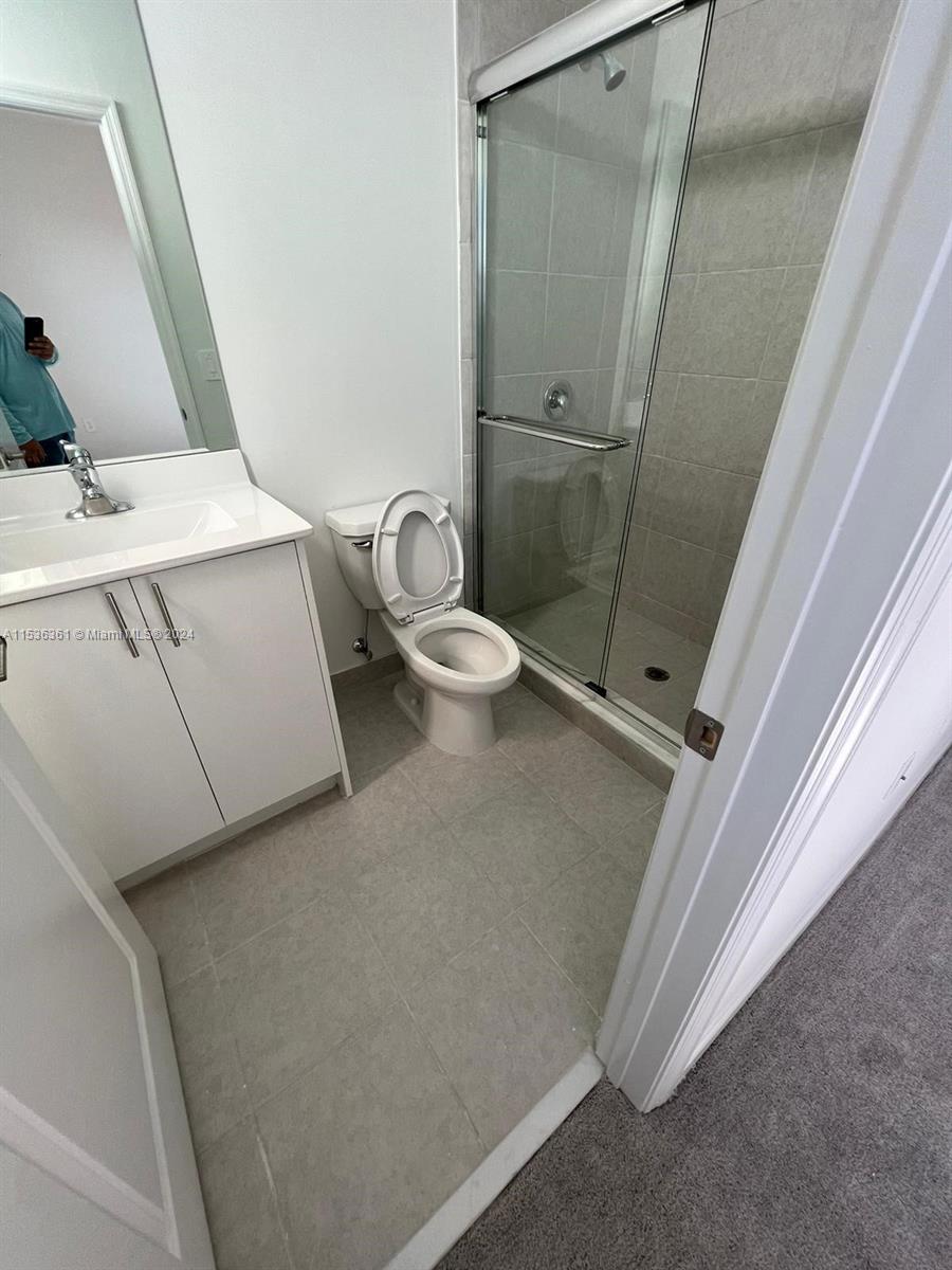 11774 Southwest 246th Street, Unit 11774 Homestead, FL 33032 - Photo 7 of 17 a bathroom with a sink and toilet