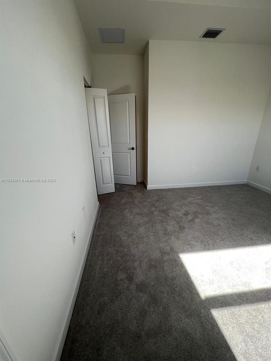 11774 Southwest 246th Street, Unit 11774 Homestead, FL 33032 - Photo 8 of 17 an empty room with windows