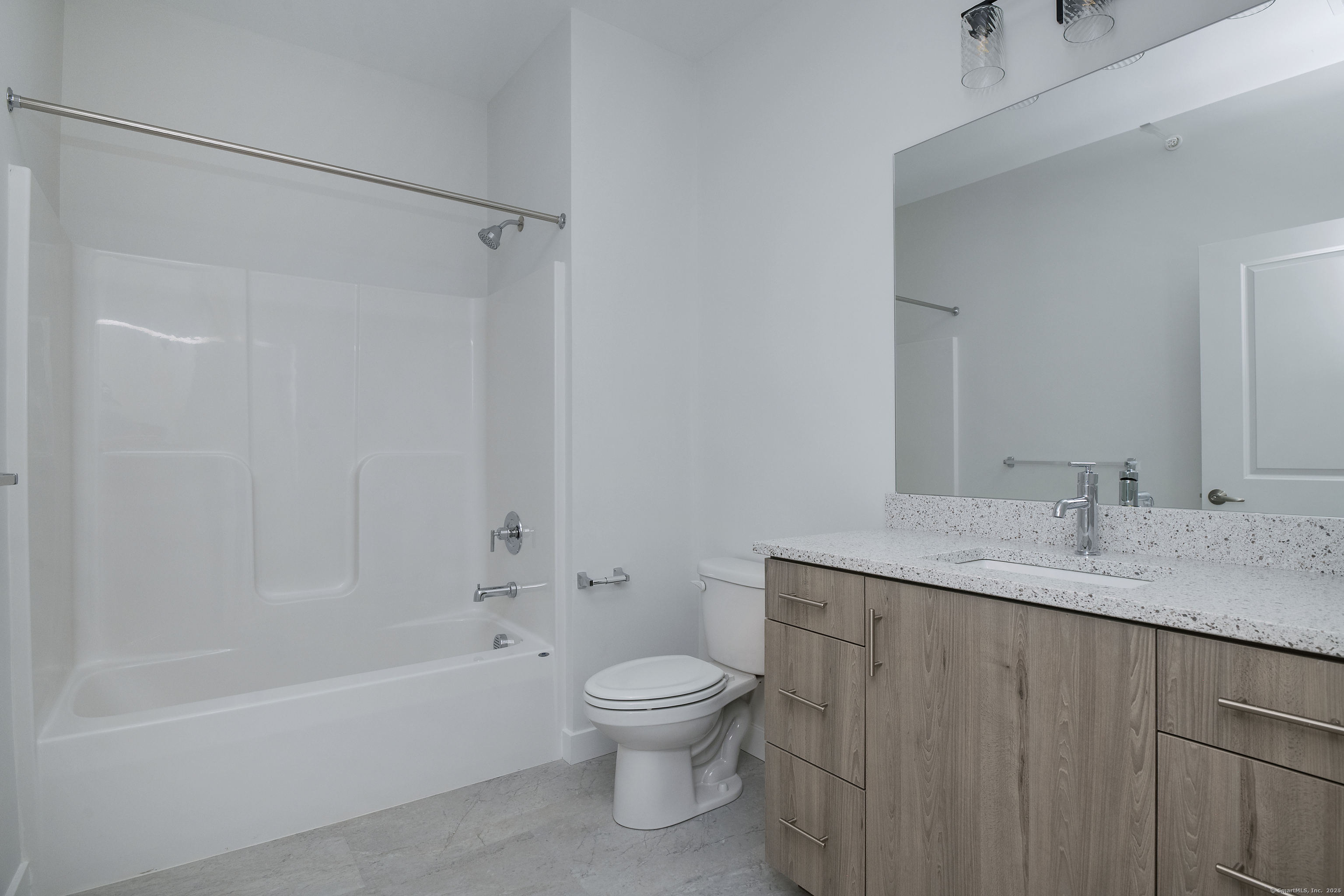 100 North Main Street, Unit 412 Bristol, CT 06010 - Photo 8 of 11 a bathroom with a granite countertop sink a toilet and shower
