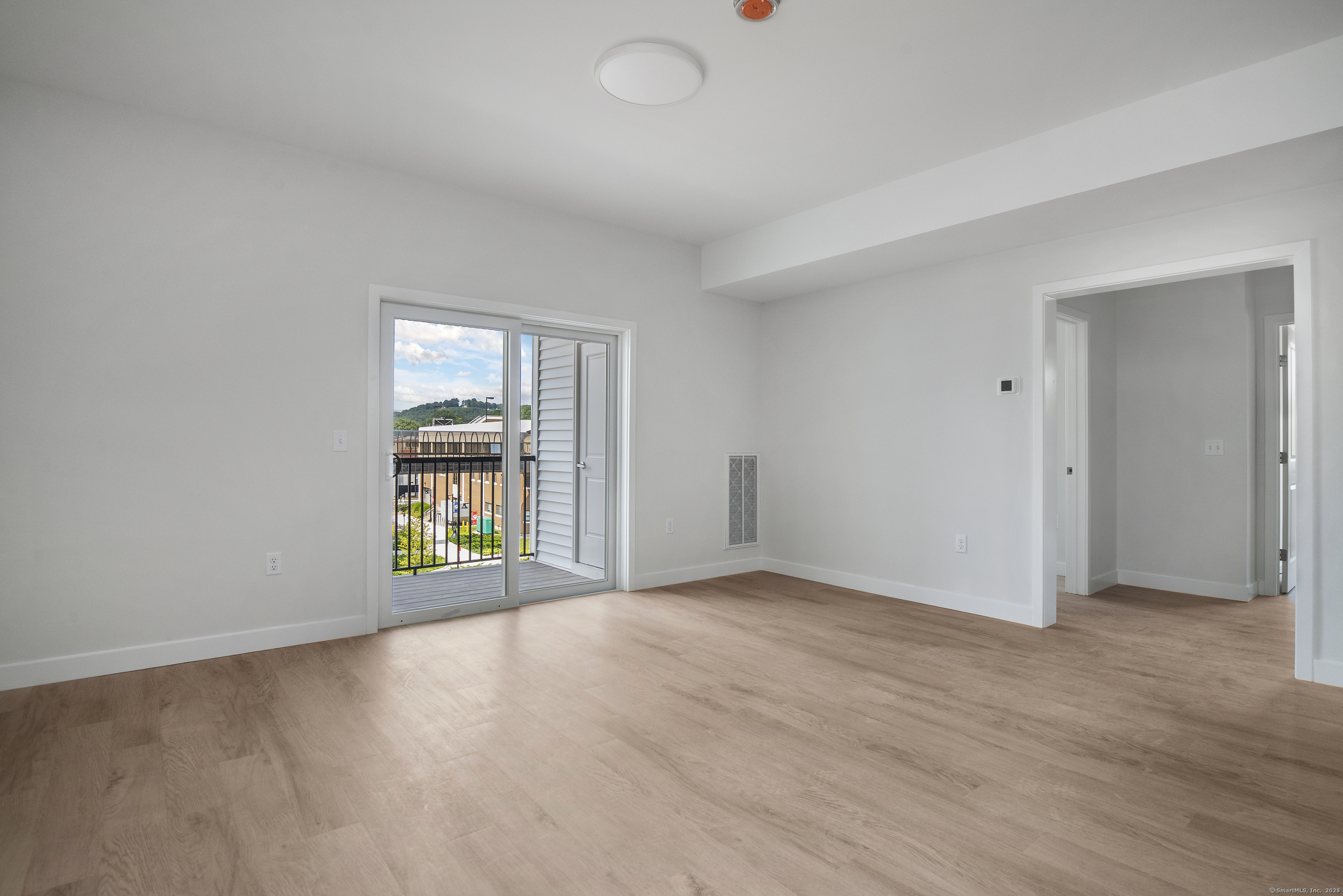 100 North Main Street, Unit 412 Bristol, CT 06010 - Photo 9 of 11 an empty room with a window and wooden floor