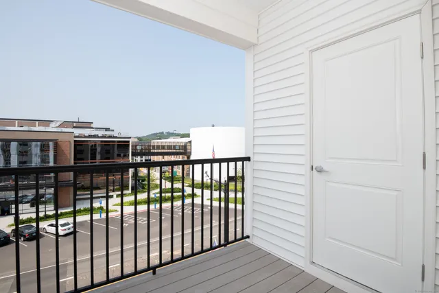 a view of a balcony with wooden floor