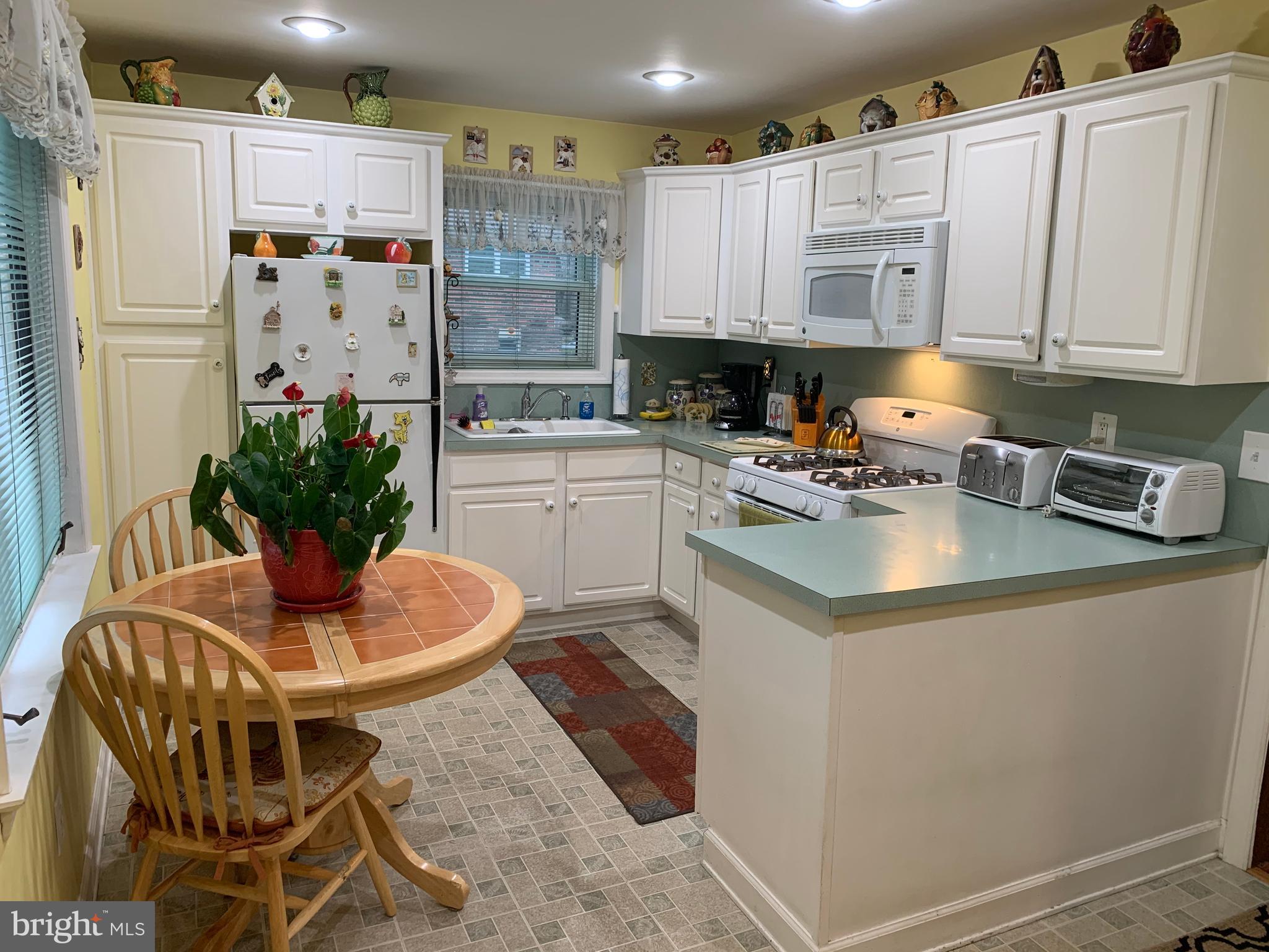 1052 Almonesson Road Westville, NJ 08093 - Photo 2 of 17 a kitchen with stainless steel appliances granite countertop a refrigerator a sink a stove and white cabinets