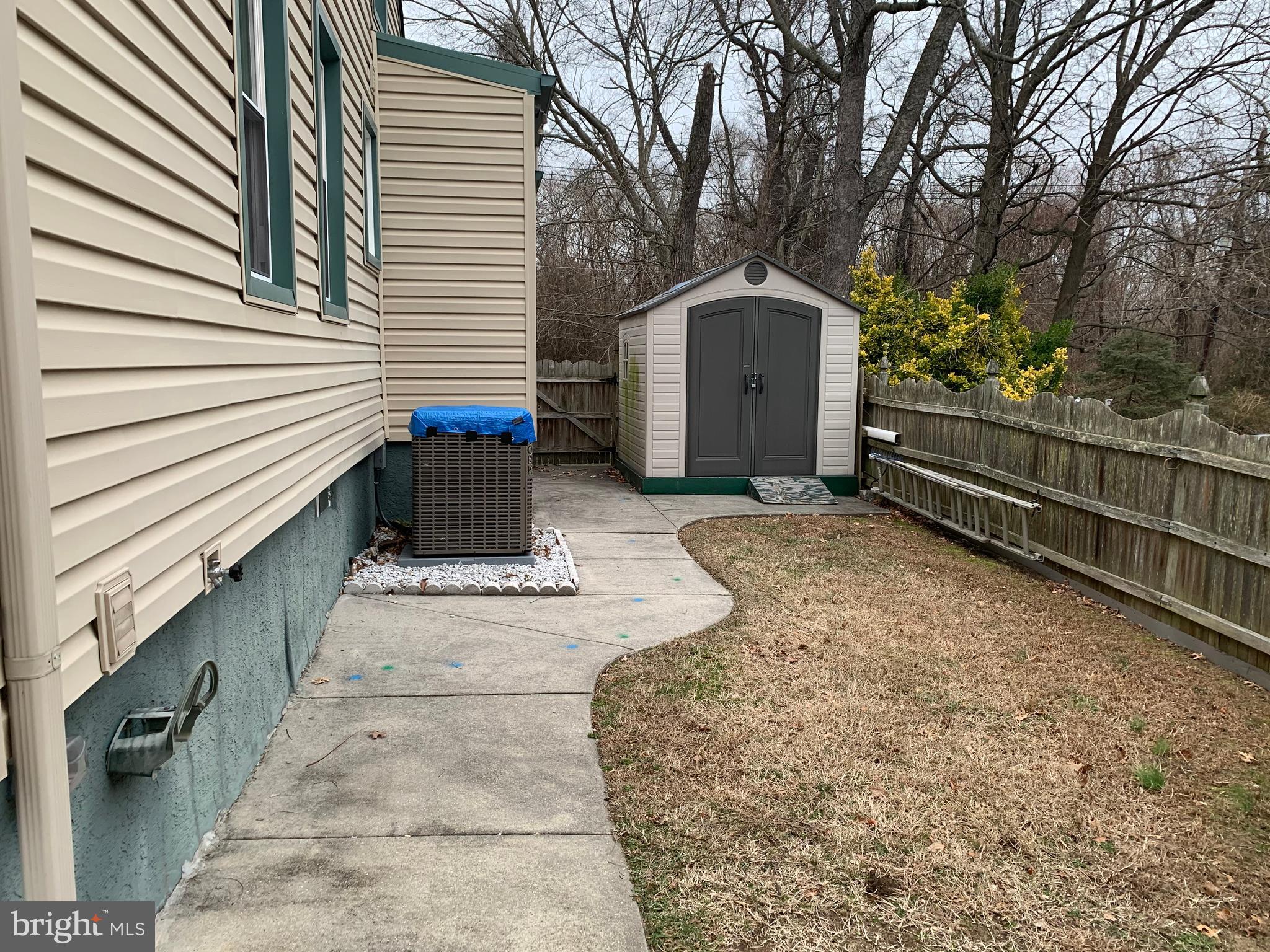 1052 Almonesson Road Westville, NJ 08093 - Photo 13 of 17 a view of backyard with wooden fence and large trees
