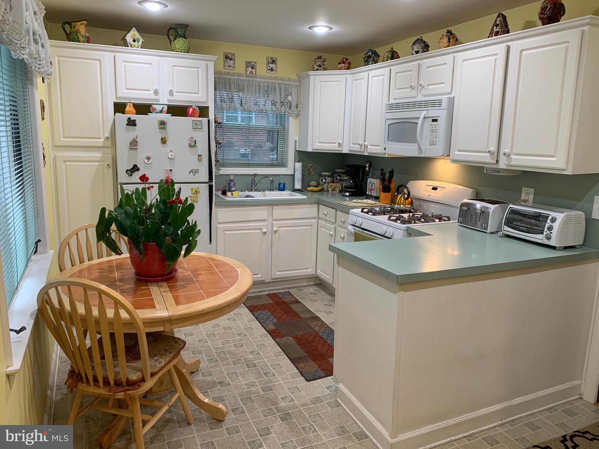 1052 Almonesson Road Westville, NJ 08093 - Photo 4 of 17 a kitchen with stainless steel appliances granite countertop a refrigerator a sink a stove and white cabinets