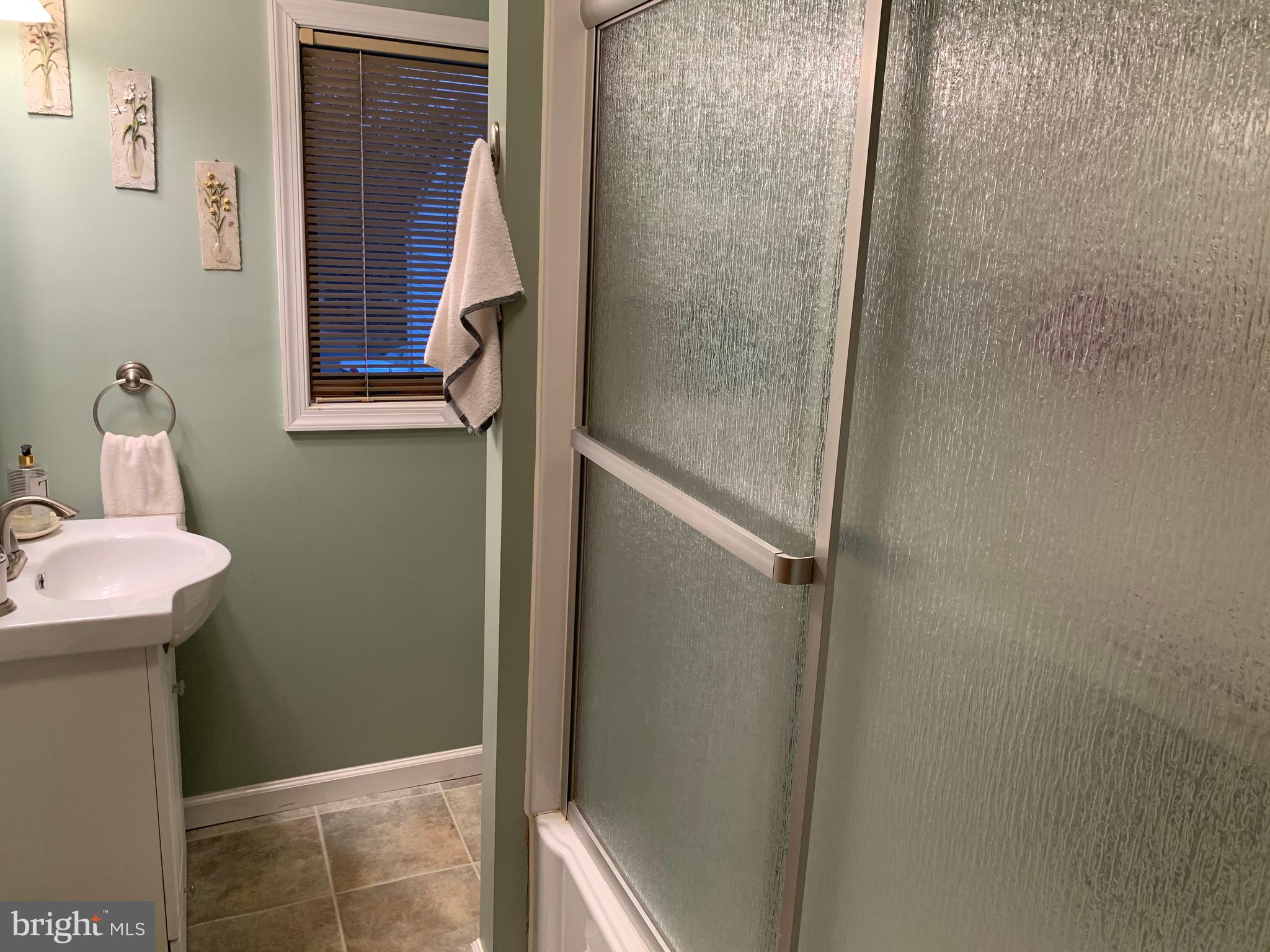 1052 Almonesson Road Westville, NJ 08093 - Photo 7 of 17 a bathroom with a sink and mirror