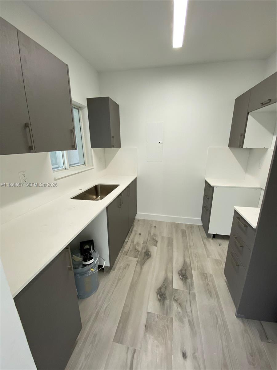 837 Southwest 8th Avenue, Unit 837 Miami, FL 33130 - Photo 5 of 8 a view of kitchen with a sink and a refrigerator